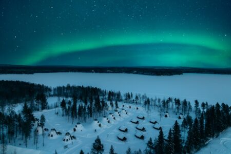 Forget Freezing: Watch the Northern Lights from the comfort of your bed in a Glass-Roofed Aurora Cabin!